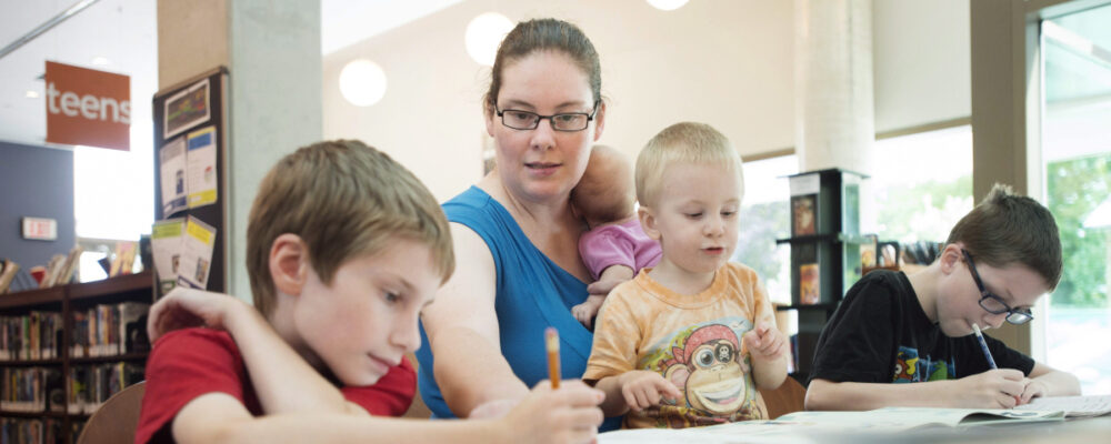 Lisa Marie Fletcher helps her children with math lessons at the Whitby Central Library in Whitby, Ont. Darren Calabrese/The Canadian Press.