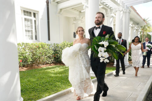 Arielle Agnelli and Bryan Arvesu head to a photo shoot after being married during a Valentine's Day group wedding ceremony, Monday, Feb. 14, 2022, outside the Flagler Museum in Palm Beach, Fla. Wilfredo Lee/AP Photo.