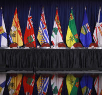 The flags of provinces and territories are displayed before a question period with premiers on the final day of the summer meeting of the Canada's Premiers at the Fairmont Empress in Victoria, B.C., on Tuesday, July 12, 2022 Chad Hipolito/The Canadian Press.
