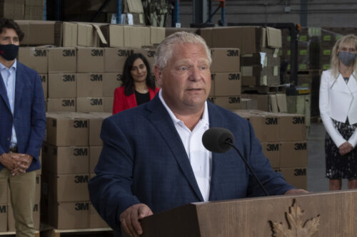 Prime Minister Justin Trudeau, Public Services and Procurement Minister Anita Anand and 3M Canada President Penny Wise look on as Ontario Premier Doug Ford speaks in Brockville on Aug. 21, 2020. Adrian Wyld/The Canadian Press.