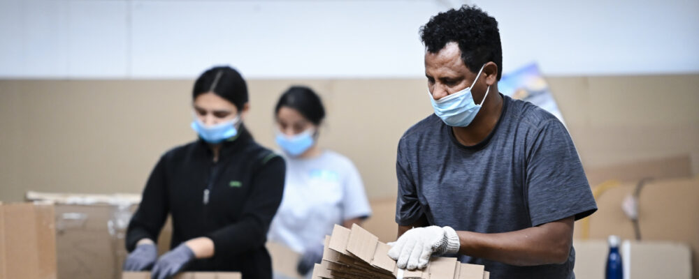 Workers manufacture partitions made from cardboard and chipboard material at TEC Business Solutions during the COVID-19 pandemic in Mississauga, Ont., on January 13, 2021. Nathan Denette/The Canadian Press.