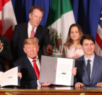 In this Nov. 30, 2018 file photo, President Donald Trump, center, sits between Canada's Prime Minister Justin Trudeau, right, and Mexico's President Enrique Pena Nieto after they signed a new United States-Mexico-Canada Agreement that is replacing the NAFTA trade deal. Martin Mejia/AP Photo.