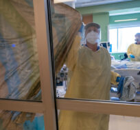 Nurses close the curtains of a patients room in the COVID-19 Intensive Care Unit at Surrey Memorial Hospital in Surrey, B.C. on June 4, 2021. Jonathan Hayward/The Canadian Press.