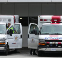 Paramedics and ambulances are seen outside the emergency department at Burnaby Hospital in Burnaby, B.C., on May 30, 2022. Darryl Dyck/The Canadian Press.