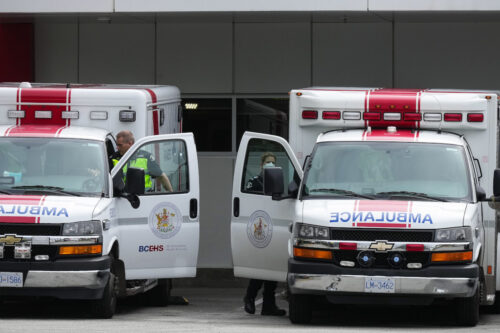 Paramedics and ambulances are seen outside the emergency department at Burnaby Hospital in Burnaby, B.C., on May 30, 2022. Darryl Dyck/The Canadian Press.