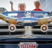A vintage vehicle with bull's horns participates in the Calgary Stampede parade in Calgary, Friday, July 8, 2022. Jeff McIntosh/The Canadian Press.