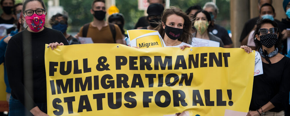 People march towards Deputy Prime Minister Chrystia Freeland's office in Toronto, during a rally led by current and former international students calling for changes to immigration rules during COVID-19, on Saturday, September 12, 2020. Tijana Martin/The Canadian Press.