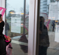A parent reads closure notices on the front door of Thorncliffe Park Public School in Toronto on Friday December 4, 2020. Frank Gunn/The Canadian Press.