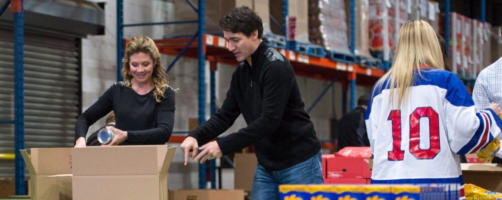 Prime Minister Justin Trudeau and his wife Sophie prepare Christmas baskets with volunteers at Moisson Montreal, a food bank, Friday, December 18, 2015 in Montreal. Paul Chiasson/The Canadian Press.