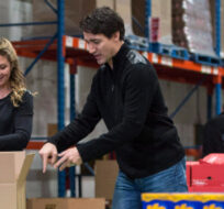 Prime Minister Justin Trudeau and his wife Sophie prepare Christmas baskets with volunteers at Moisson Montreal, a food bank, Friday, December 18, 2015 in Montreal. Paul Chiasson/The Canadian Press.