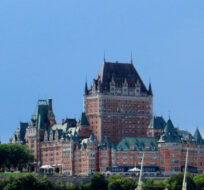 Quebec City's iconic Fairmont Le Chateau Frontenac dominates the city skyline from the ferry crossing the St. Lawrence River, Aug. 15, 2015. Cal Woodward/AP Photo.