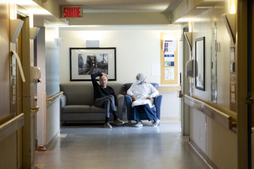 A resident talks with a health-care worker in a COVID-19 infected ward at Idola Saint-Jean long-term care home in Laval, Que. on February 25, 2022. Graham Hughes/The Canadian Press.