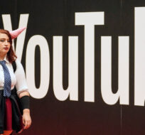 A cosplayer walks at the YouTube exhibition stands at the Gamescom computer gaming fair in Cologne, Germany, Thursday, Aug. 25, 2022. Martin Meissner/AP Photo.