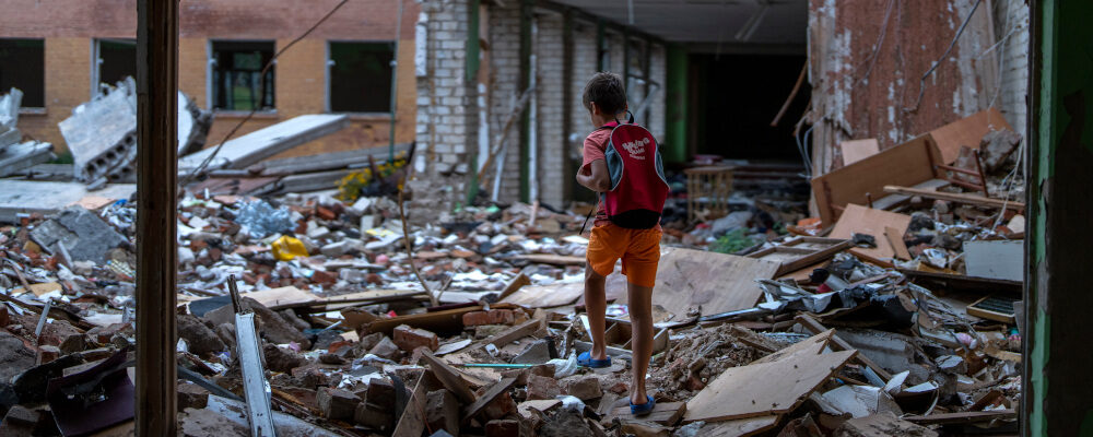 Ivan Hubenko, 11, walks on the rubble of his former school which was bombed by Russian forces on March 3, in Chernihiv, Ukraine, Tuesday, Aug. 30 , 2022. Emilio Morenatti/AP Photo.