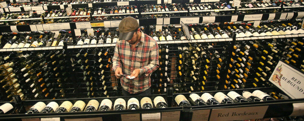 A worker at a state liquor store changes prices on wine, liquor and higher-alcohol beer, June 30, 2017, near downtown Salt Lake City. Rick Bowmer/AP Photo.