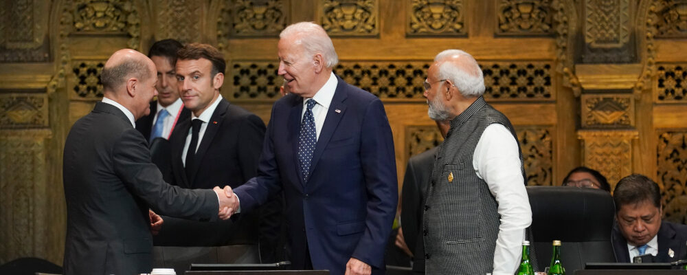 U.S. President Joe Biden shakes hands with German Chancellor Olaf Scholz as French President Emmanuel Macron and India's Prime Minister Narendra Modi watches during the first working session of the G20 leaders' summit  in Nusa Dua, Indonesia, Tuesday, Nov. 15, 2022. (Kevin Lamarque/AP Photo.