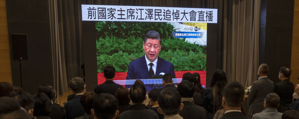 Residents watch a live broadcast of the memorial service for late former Chinese President Jiang Zemin  in Hong Kong, Tuesday, Dec. 6, 2022. Vernon Yuen/AP Photo.