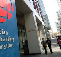 People walk into the CBC building in Toronto on April 4, 2012. Nathan Denette/The Canadian Press.