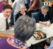 Prime Minister Justin Trudeau meets with seniors during a visit to the Whitby Seniors' Activity Centre on Oct. 11, 2022. Alex Lupul/The Canadian Press.