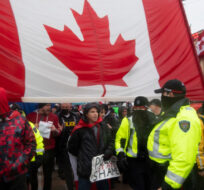 Police attempt to hand out notices on the 21st day of the "Freedom Convoy" protest, in Ottawa, on Thursday, Feb. 17, 2022. Justin Tang/The Canadian Press.