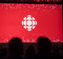 The CBC logo is projected onto a screen during the CBC's annual upfront presentation in Toronto on May 29, 2019. Tijana Martin/The Canadian Press.