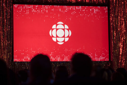 The CBC logo is projected onto a screen during the CBC's annual upfront presentation in Toronto on May 29, 2019. Tijana Martin/The Canadian Press.