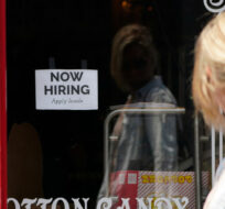 A "NOW HIRING" sign is posted in the window of The Wharf Chocolate Factory at Fisherman's Wharf in Monterey, Calif., Friday, Aug. 6, 2021. Rich Pedroncelli/AP Photo.