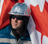 James, no last name given, prepares to protest COVID-19 mandates in Edmonton, Tuesday, Feb. 22 2022. His tinfoil hard hat is meant to claim and disarm accusations of conspiracy theorists. Amber Bracken/The Canadian Press. 
