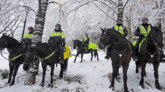 Montreal mounted police officers stay out of the snow in front of the COP15 conference as the city deals with the first major snowstorm of the season, Friday, December 16, 2022  in Montreal. Ryan Remiorz/The Canadian Press. 