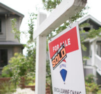 A real estate sign is pictured in Vancouver, B.C., Tuesday, June, 12, 2018. Jonathan Hayward/The Canadian Press. 