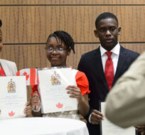 The Letang family from Haiti get their photo taken after becoming New Canadians after taking the Oath of Citizenship on Parliament Hill in Ottawa on Wednesday, April 17, 2019. Sean Kilpatrick/The Canadian Press. 