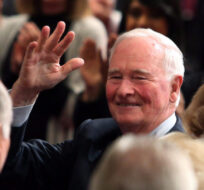 Former Governor General David Johnston waves as guests in the Senate chamber applaud his tenure in the position during the installation ceremony for Canada's 29th Governor General, Julie Payette, in Ottawa on Monday, October 2, 2017. Fred Chartrand/The Canadian Press. 