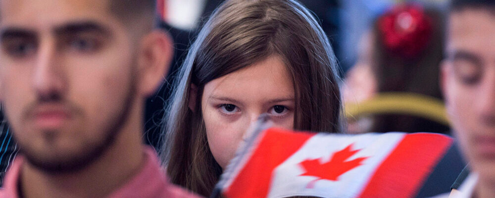 Lily Nicole Woon holds a Canadian flag after receiving her citizenship at ceremony hosted by Immigration, Refugees and Citizenship Canada at Government House in Halifax on Monday, Nov. 20, 2017. Andrew Vaughan/The Canadian Press. 