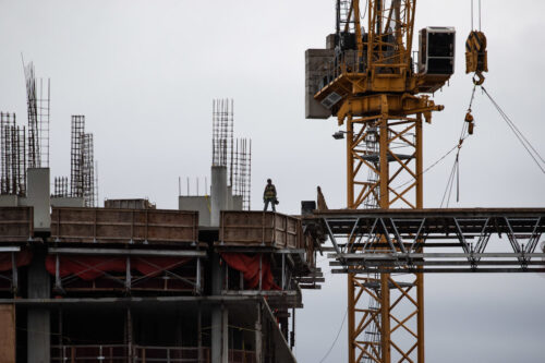 A tradesperson stands atop a condo tower under construction, in Burnaby, B.C., on March 2, 2022. Darryl Dyck/The Canadian Press.