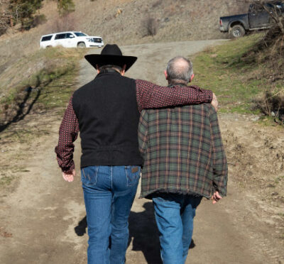 Shackan Indian Band Chief Arnie Lampreau (Swakum), left, puts his arm around Paulus Velt, west of Merritt, B.C., on Thursday, March 24, 2022. Darryl Dyck/The Canadian Press. 