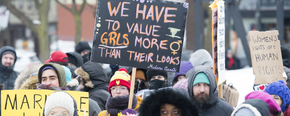 People hold up signs during the Women's March in Montreal, Saturday, January 19, 2019. Graham Hughes/The Canadian Press. 