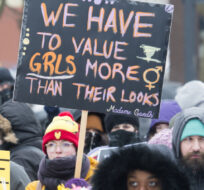 People hold up signs during the Women's March in Montreal, Saturday, January 19, 2019. Graham Hughes/The Canadian Press. 
