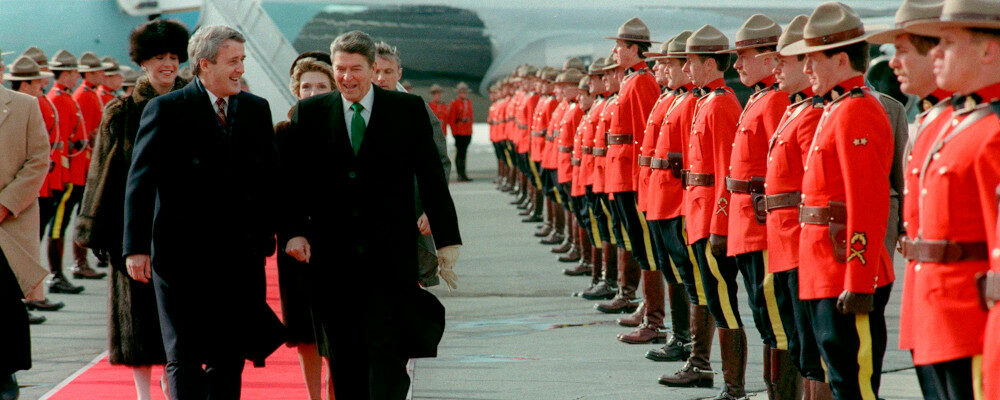 Prime Minister Brian Mulroney and President Ronald Reagan walk past a line of Royal Canadian Mounted Police, March 17, 1985, at the Quebec City airport.  Paul Chiasson/The Canadian Press. 