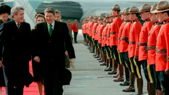 Prime Minister Brian Mulroney and President Ronald Reagan walk past a line of Royal Canadian Mounted Police, March 17, 1985, at the Quebec City airport.  Paul Chiasson/The Canadian Press. 