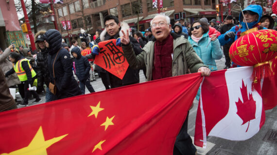 People carry Chinese and Canadian flags while marching in the Chinese New Year Parade in Vancouver on Sunday, Feb. 10, 2019. Darryl Dyck/The Canadian Press. 