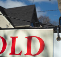 A real estate sold sign is shown in a Toronto west end neighbourhood May 16, 2020. Graeme Roy/The Canadian Press. 