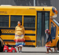 Members of the Tsuut'ina Nation gather at a school bus in Calgary, Alta., Monday, June 7, 2021. Jeff McIntosh/The Canadian Press. 