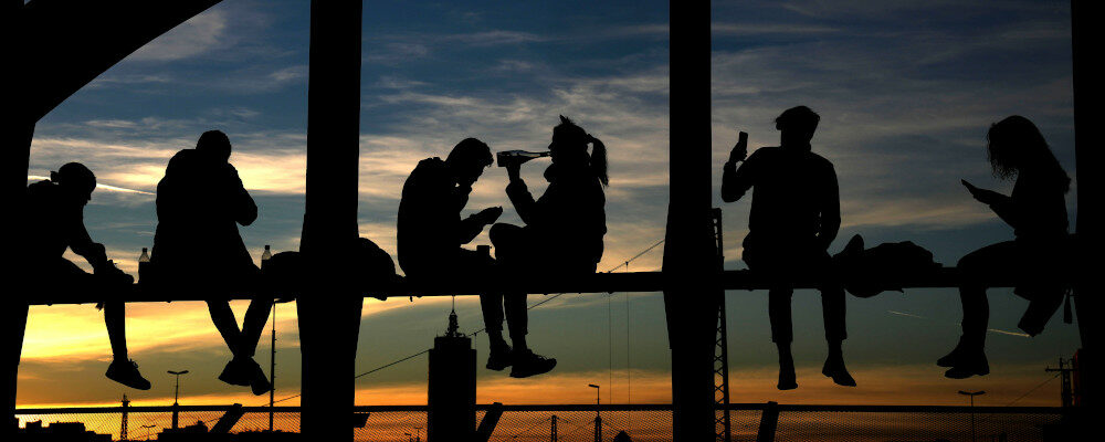 People drink wine, take pictures and enjoy the sunset at the bridge 'Hackerbruecke' in Munich, Germany, Sunday, Oct. 31, 2021. Matthias Schrader/AP Photo.