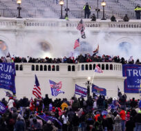Violent protesters, loyal to President Donald Trump, storm the Capitol, Jan. 6, 2021, in Washington. John Minchillo/AP Photo. 