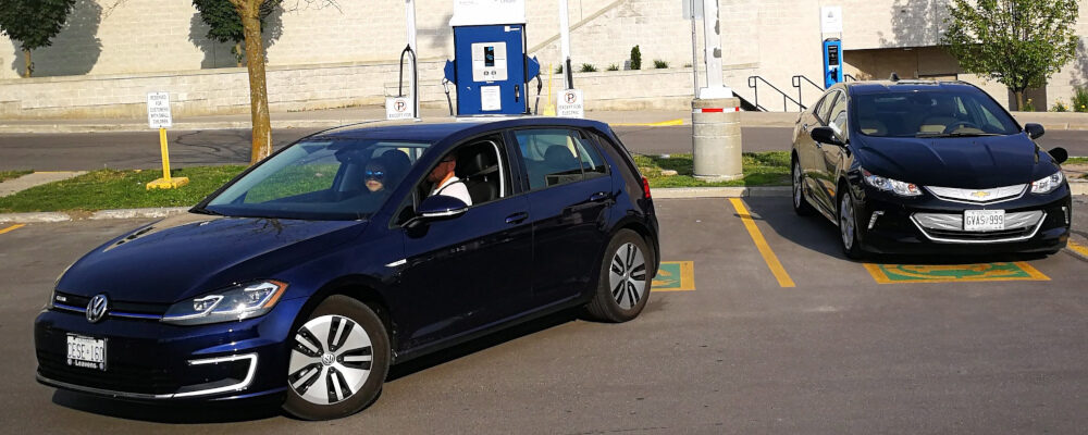 A Chevrolet Volt is plug into a charging station as a Volkswagen e-Golf backs into a parking spot at Lansdowne Mall in Peterborough, Ontario on Sunday June 17, 2018. Doug Ives/The Canadian Press. 