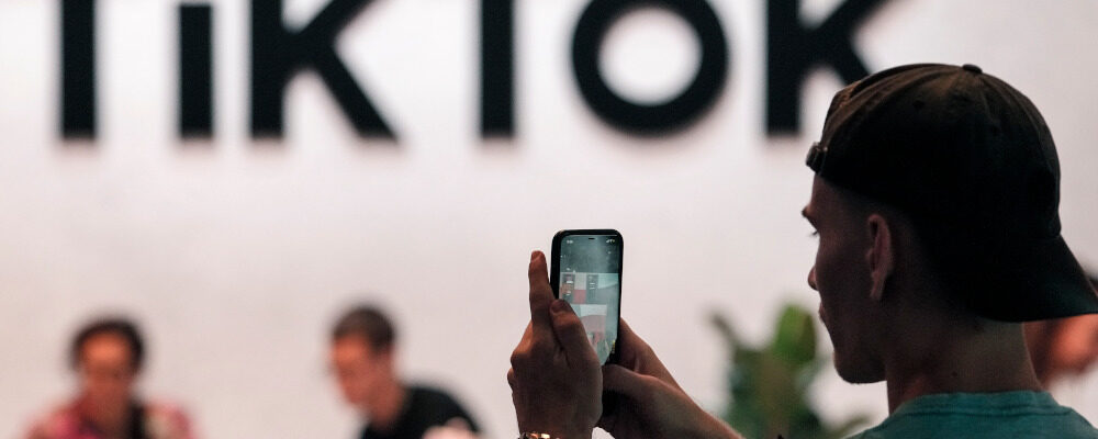 A visitor makes a photo at the TikTok exhibition stands at the Gamescom computer gaming fair in Cologne, Germany, Thursday, Aug. 25, 2022. Martin Meissner/AP Photo.