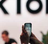 A visitor makes a photo at the TikTok exhibition stands at the Gamescom computer gaming fair in Cologne, Germany, Thursday, Aug. 25, 2022. Martin Meissner/AP Photo.