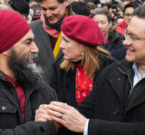 NDP leader Jagmeet Singh, left, and Conservative leader Pierre Poilievre greet each other before marching in the Lunar New Year parade, in Vancouver, on January 22, 2023. Darryl Dyck/The Canadian Press.