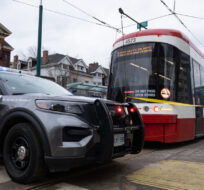 Police cars surround a TTC streetcar on Spadina Ave., in Toronto on Tuesday, January 24, 2023.  Arlyn McAdorey/The Canadian Press. 