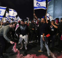 Demonstrators block a highway in Tel Aviv, Israel, during a protest against plans by Prime Minister Benjamin Netanyahu's government to overhaul the Israel's judicial system on March 18, 2023. Ohad Zwigenberg/AP Photo.